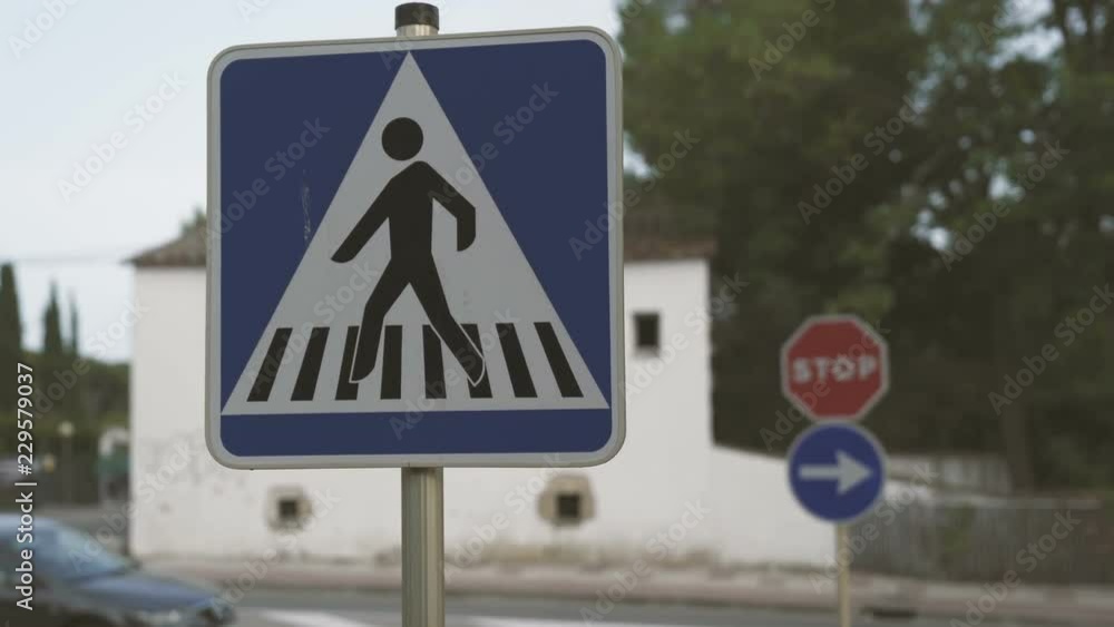 Crosswalk street sign in the city street on the day Crosswalk street sign in the city street on the day