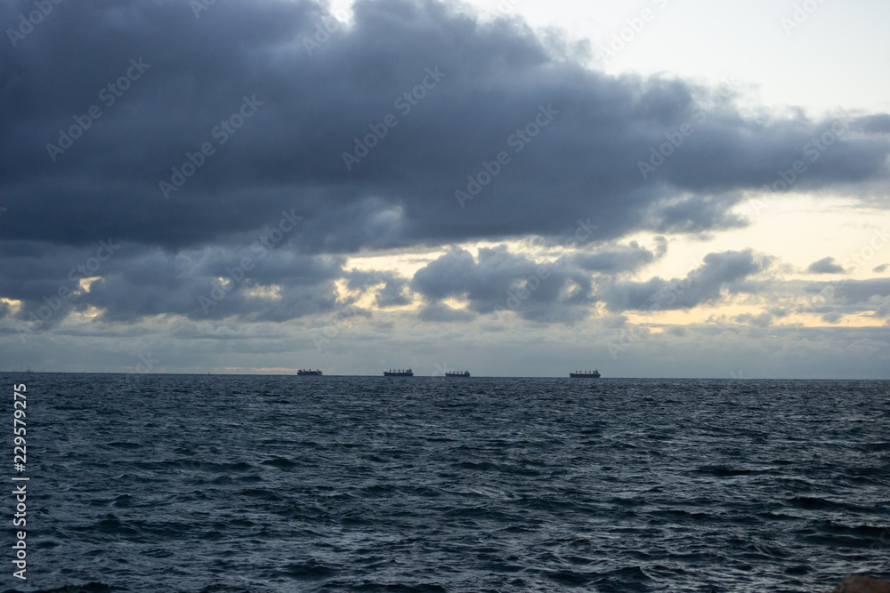Landscape of the beach at sunset in a cloudy day Landscape of the beach at sunset in a cloudy day