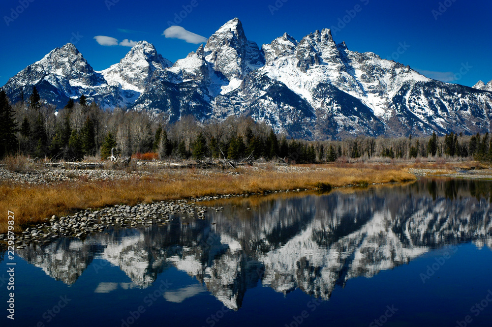 Reflection of Teton Mountain Range in River Lake or Pond Water