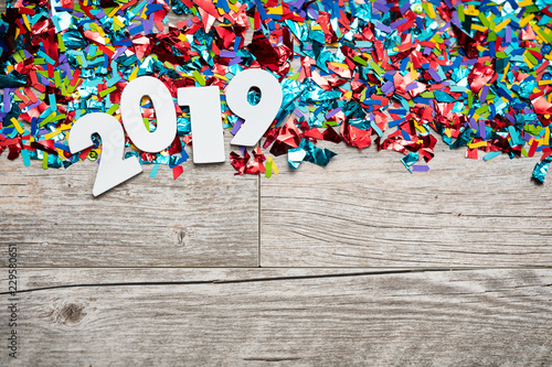 NYE2019: Wooden 2019 Year Number On Confetti Background