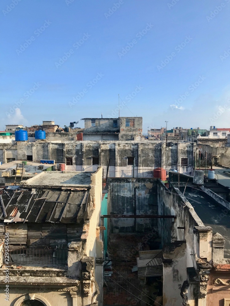 Scenic panoramic view in the sunrise morning hours over the roofs of Havana (Habana) city, capital of the Caribbean island of Cuba and a tourist destination with a vintage latin downtown neighborhood Scenic panoramic view in the sunrise morning hours over the roofs of Havana (Habana) city, capital of the Caribbean island of Cuba and a tourist destination with a vintage latin downtown neighborhood