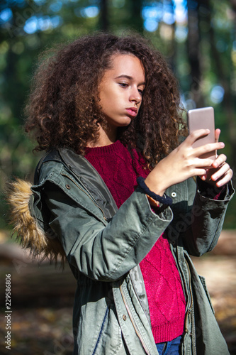 Cute curly hair teen girl w...
