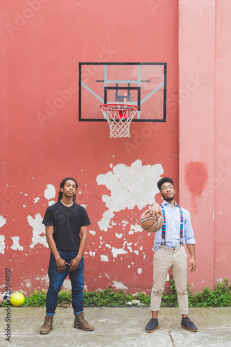 two young men outdoor playing basket - competition, sport, healthy concept