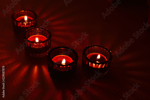 Scented candles in glass candlesticks in a room in the evening. Romantic atmosphere.