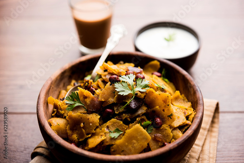 Homemade Kothu Parotta/ Paratha or Stir Fried Leftover Chapati Masala or  fodnichi poli in marathi, served in a bowl or plate with curd and hot tea. Selective focus photo