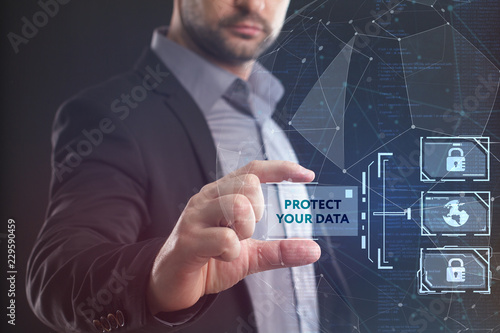 The concept of business, technology, the Internet and the network. A young entrepreneur working on a virtual screen of the future and sees the inscription: Protect your data