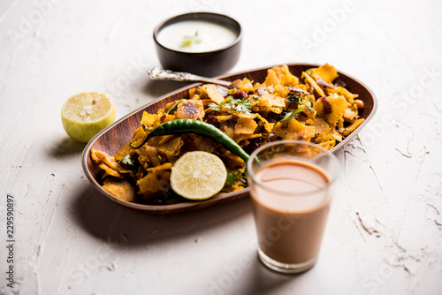 Homemade Kothu Parotta/ Paratha or Stir Fried Leftover Chapati Masala or  fodnichi poli in marathi, served in a bowl or plate with curd and hot tea. Selective focus photo