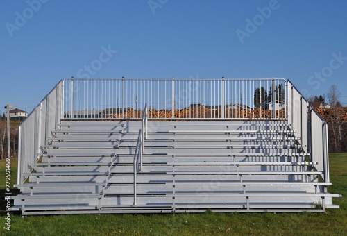 Front view of portable steel bleachers on the field  photo