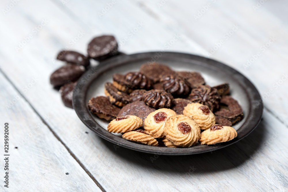 shortbread butter cookies with chocolate and plum jam on a white wooden table shortbread butter cookies with chocolate and plum jam on a white wooden table
