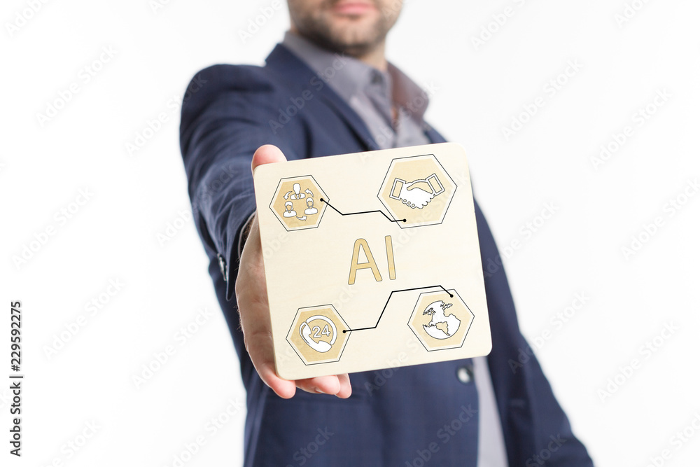 The concept of business, technology, the Internet and the network. Young businessman showing inscription: AI