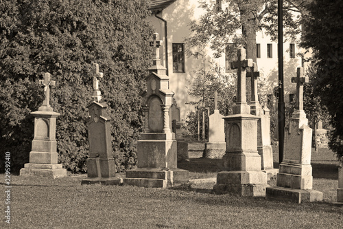 ochre photo of old tombstones on the cemetery in Ostrava - Hrabova, Czech Republic