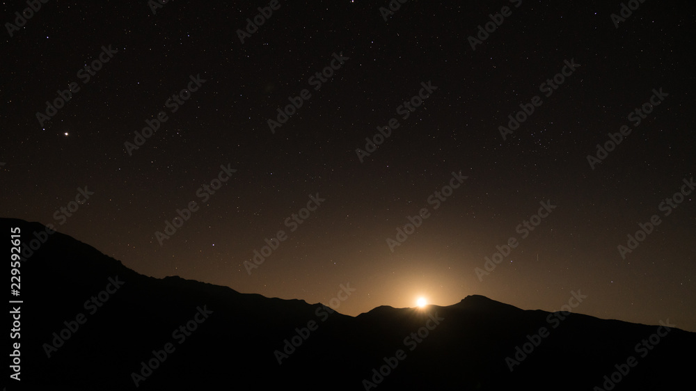 Starry night with moon setting beneath the mountains, Artvin, Turkey