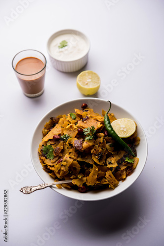 Homemade Kothu Parotta/ Paratha or Stir Fried Leftover Chapati Masala or  fodnichi poli in marathi, served in a bowl or plate with curd and hot tea. Selective focus photo