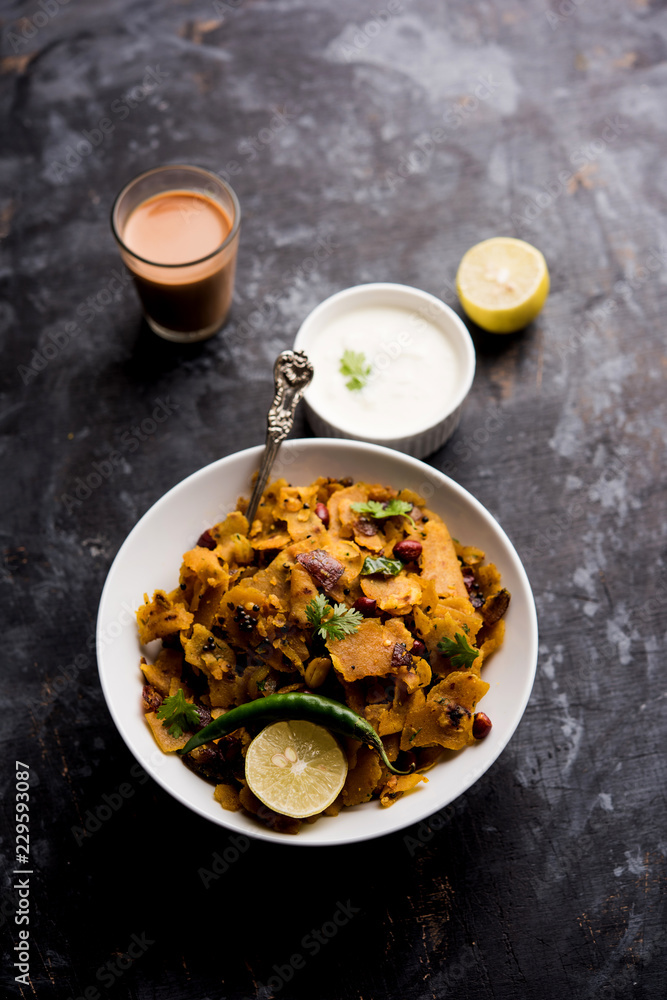 Fototapeta premium Homemade Kothu Parotta/ Paratha or Stir Fried Leftover Chapati Masala or fodnichi poli in marathi, served in a bowl or plate with curd and hot tea. Selective focus
