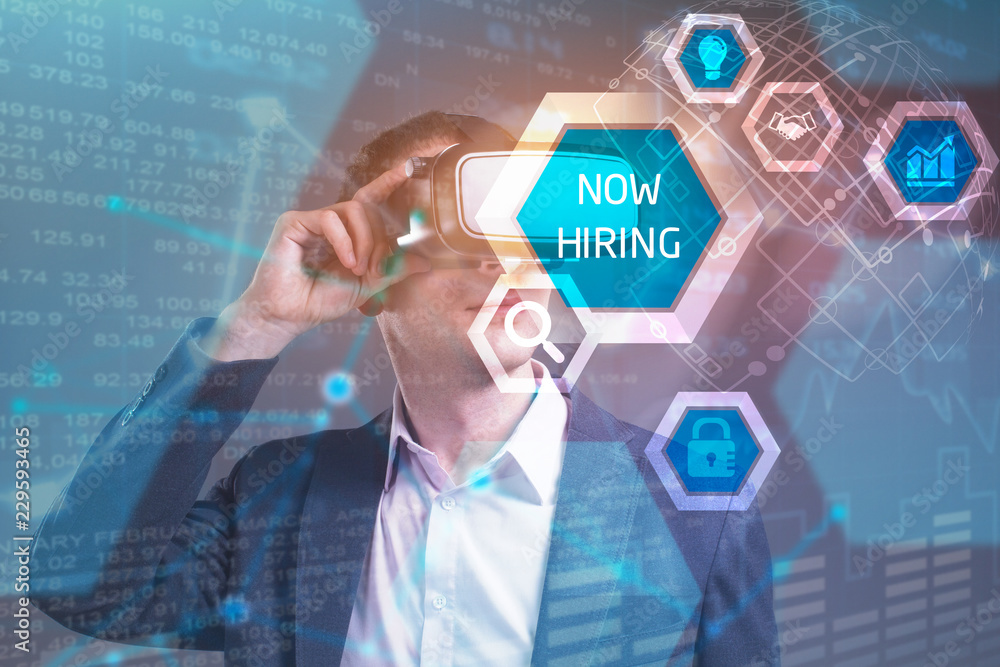 Obraz premium Business, Technology, Internet and network concept. Young businessman working in virtual reality glasses sees the inscription: now hiring