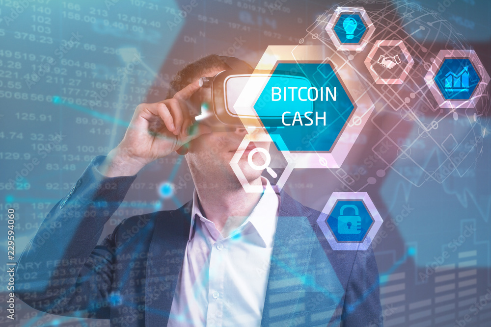 Obraz premium Business, Technology, Internet and network concept. Young businessman working in virtual reality glasses sees the inscription: bitcoin cash