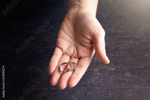 Person Offering a Pair of Wedding Rings photo