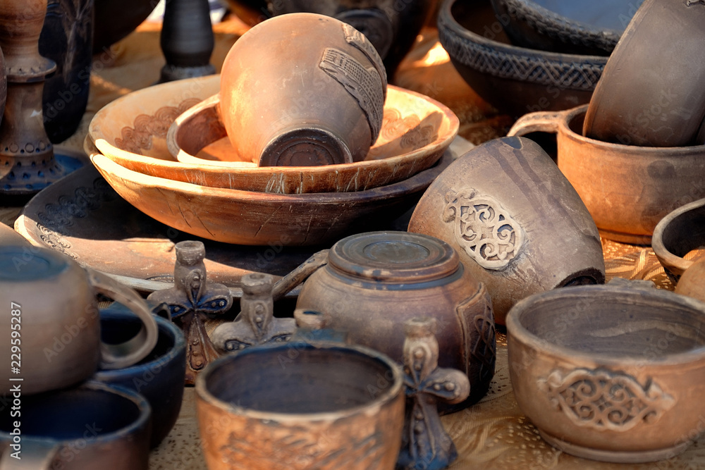 Collection of ancient pottery in beams setting the sun.