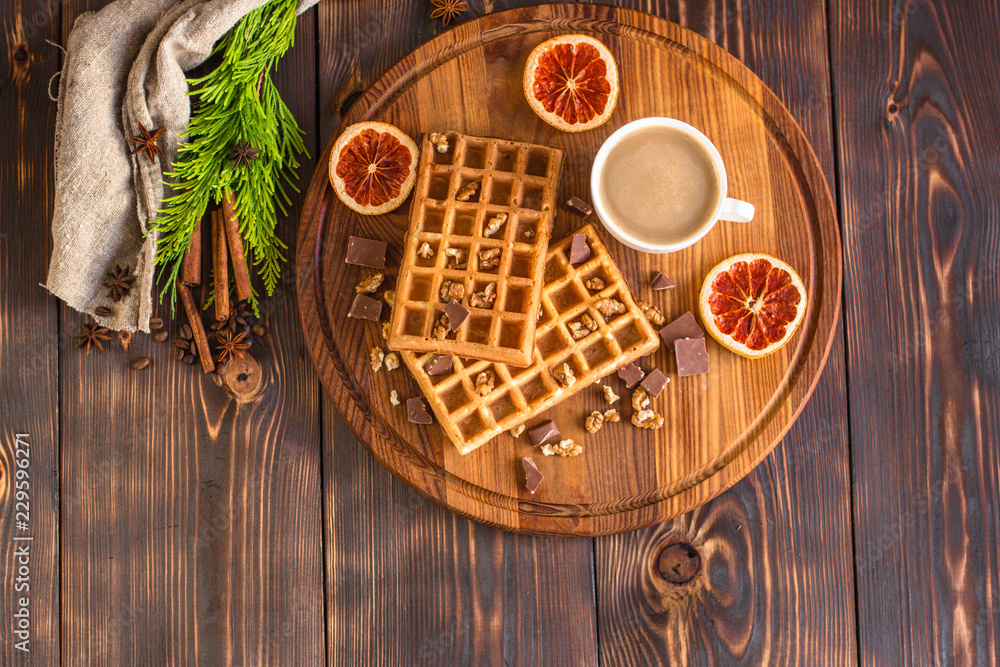 fresh belgian waffles, tasty jam and latte coffee on a wooden background. top view. fresh belgian waffles, tasty jam and latte coffee on a wooden background. top view.