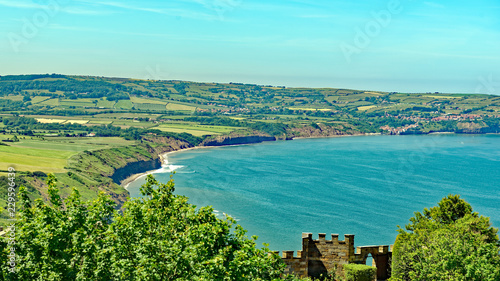 View across the bay from Ravenscar of the popular village of Robin Hood's Bay, North Yorkshire, England photo