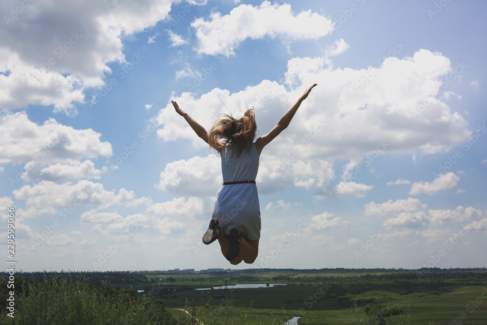 Young hipster girl is having fun in summer holidays. Woman in sunglasses is jumping high on the hill with a beautiful nature view. Freedom and travel lifestyle concept. Happy emotions and laugh. Young hipster girl is having fun in summer holidays. Woman in sunglasses is jumping high on the hill with a beautiful nature view. Freedom and travel lifestyle concept. Happy emotions and laugh.