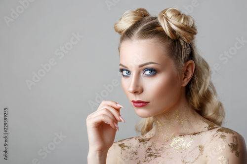 portrait of beautiful blonde woman with makeup beauty photoshoot on background