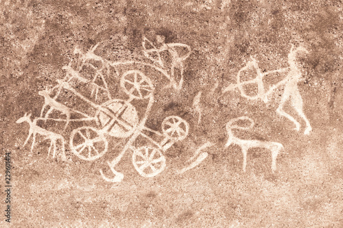 Ancient image of people and animals on the wall of the cave. ancient history, archeology.