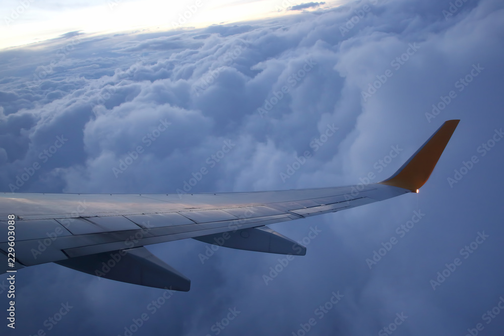 The wing of an airplane above the clouds The wing of an airplane above the clouds