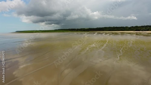 Low altitude fight over a sandy muddy beach Awala Yalimapo village Guiana photo