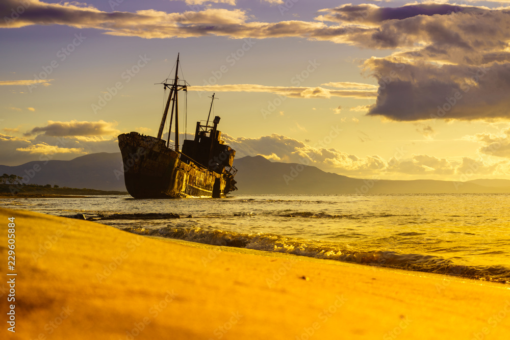 Rusty broken shipwreck on sea shore Rusty broken shipwreck on sea shore