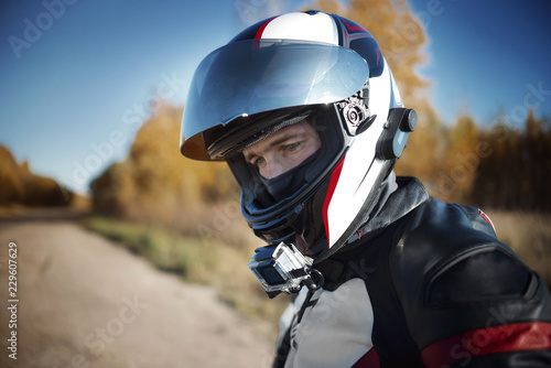 biker in a helmet looking away in nature © Михаил Гужов