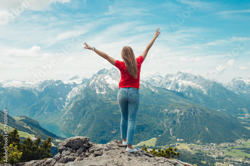 young woman on top of mountain