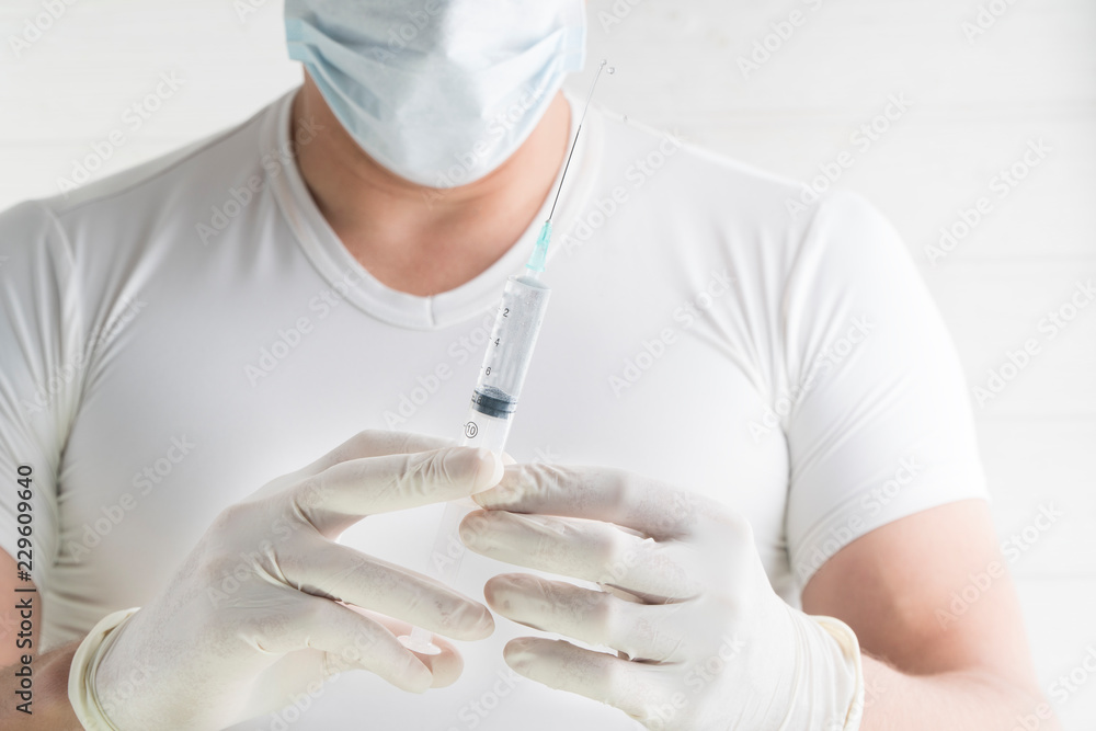 Hand holding syringe isolated on white Hand holding syringe isolated on white