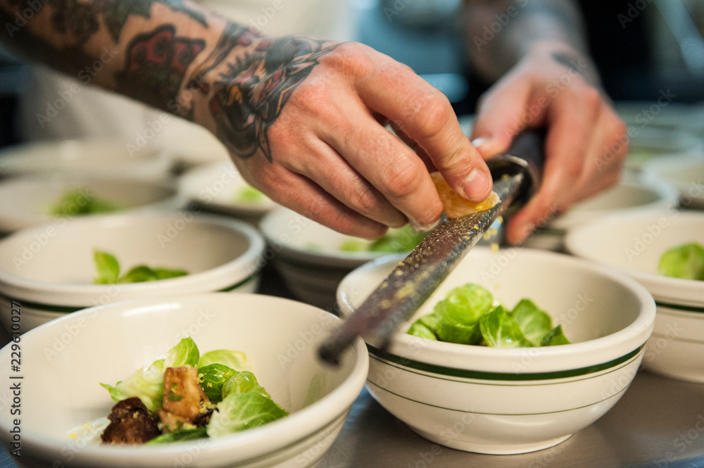 Chef preparing brussel sprout dish in restaurant Chef preparing brussel sprout dish in restaurant