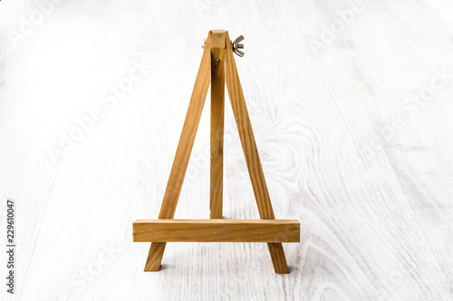 Wooden easel on white background