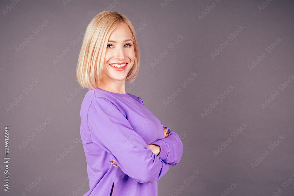 portrait of a beautiful makeup blonde fitness trainer woman slim in violet sports suit posing and arms crossed on chest in the studio on a black background,hip hop dancer dancing happy model smiling portrait of a beautiful makeup blonde fitness trainer woman slim in violet sports suit posing and arms crossed on chest in the studio on a black background,hip hop dancer dancing happy model smiling