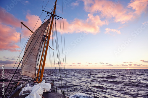 Old sailing ship mast at sunset, travel and adventure concept, color toned picture.