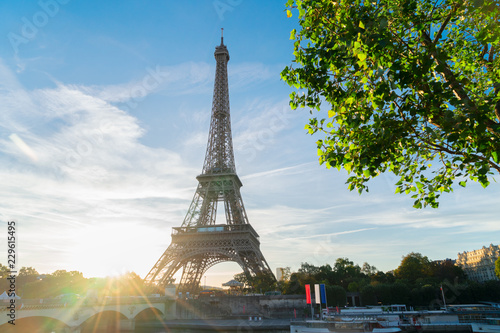 Eiffel Tower famous landmark with shining sun at sunrise, Paris, France