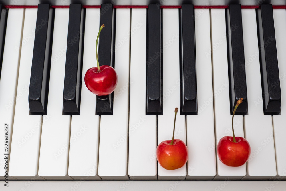 Piano chord shown by cherries on the key - A#/Bb foto de Stock | Adobe Stock