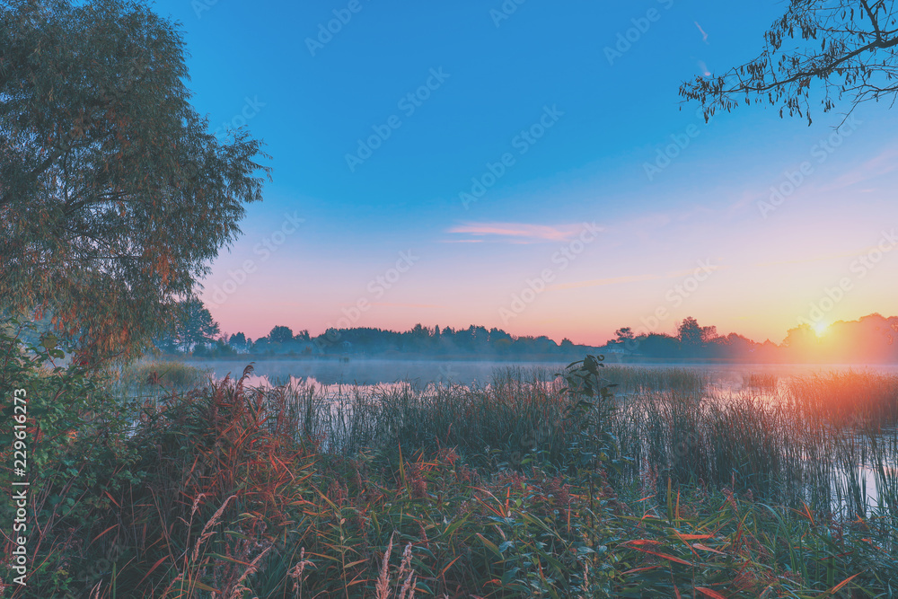 Early morning, sunrise over the lake. Rural landscape. HDR
