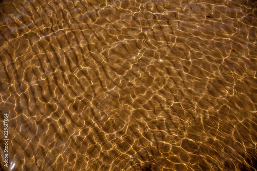 sandy bottom through the transparent water