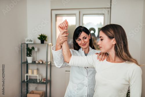 Physiotherapist working with patient in clinic.