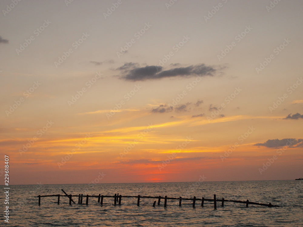 Playa Ancón, Espíritu Santo, Cuba - June 28, 2018: Spectacular sunset on the Ancon beach with all golden and blue toness Playa Ancón, Espíritu Santo, Cuba - June 28, 2018: Spectacular sunset on the Ancon beach with all golden and blue toness
