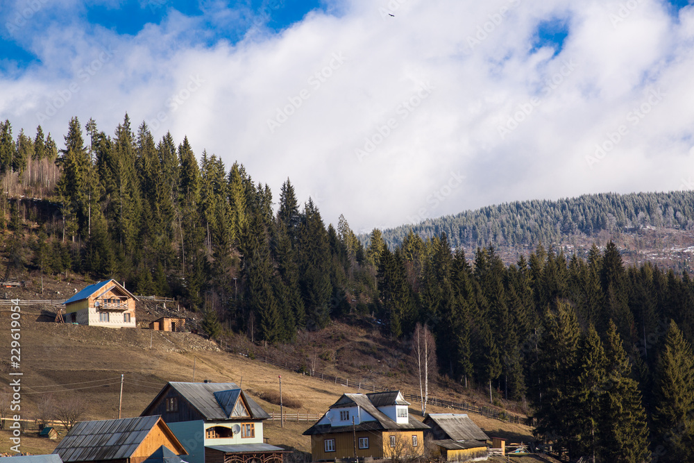 Winter view of winter ski resort with houses, cottages and woods in Bukovel, Carpathian mountains, Ukraine.