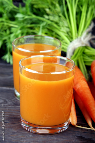 Homemade fresh carrot juice in a transparent glass beaker.