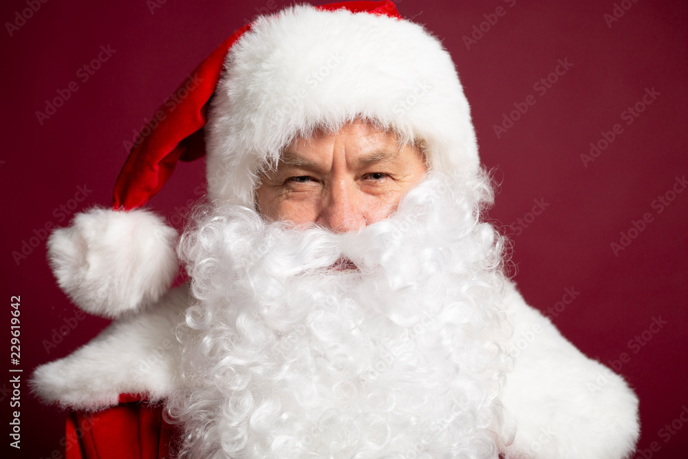 Happy grandfather Santa Clause portrait isolated on red background Happy grandfather Santa Clause portrait isolated on red background
