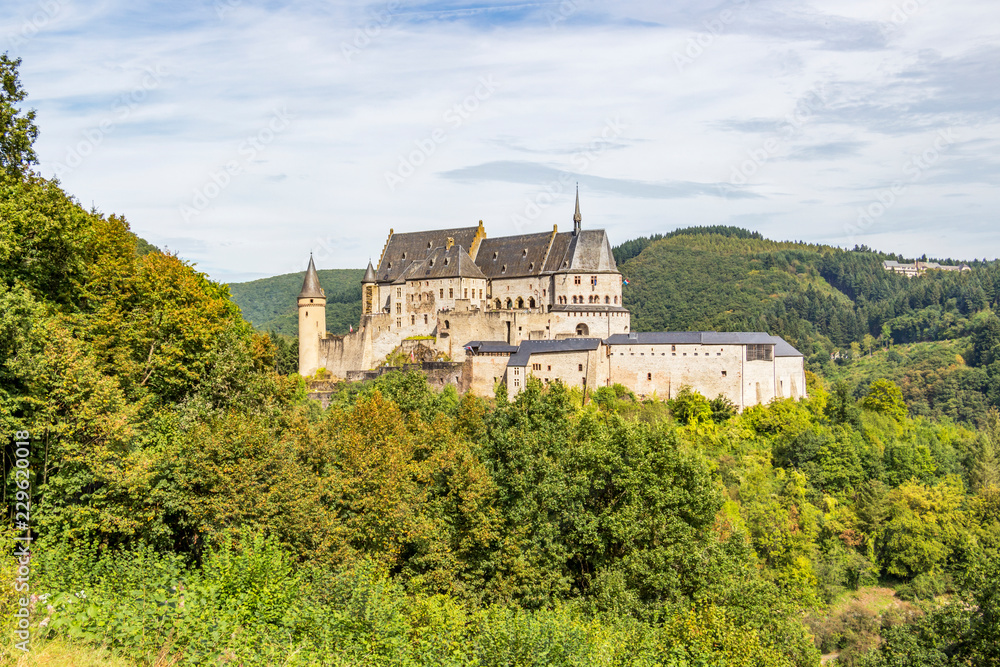 Vianden Castle in Luxembourg on a rocky promontory, panoramic view from the main road