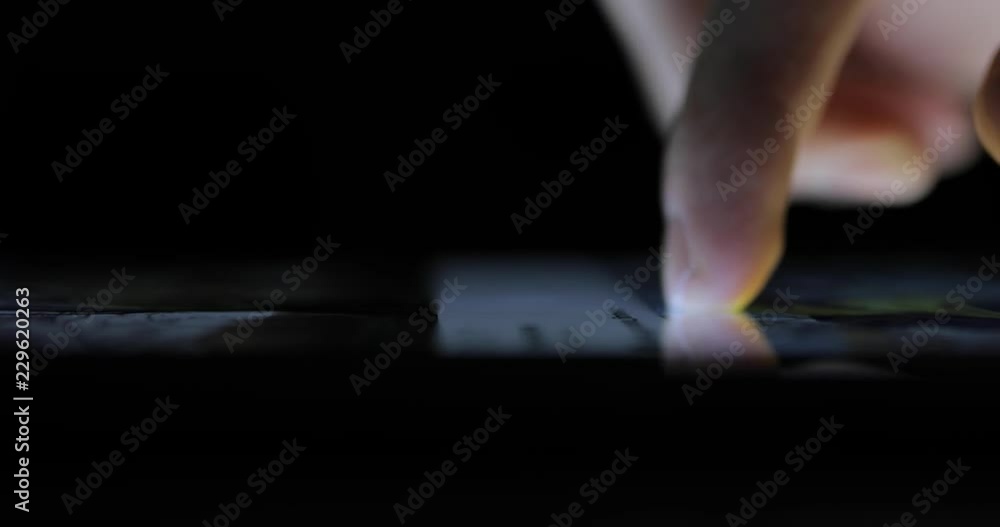 Male finger browsing touchscreen monitor of tablet PC closeup Male finger browsing touchscreen monitor of tablet PC closeup
