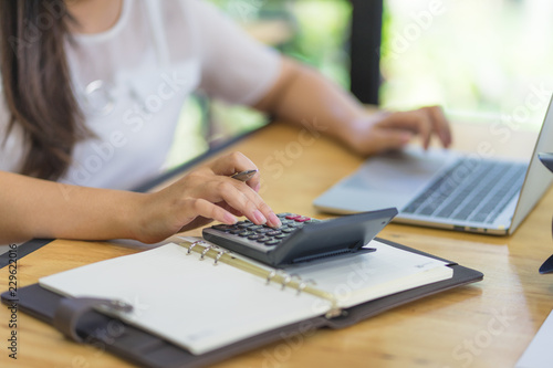 Business financing accounting banking concept. Top view of female accountant or banker making calculations. Savings, finances and economy concept