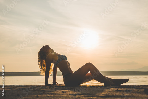 Young attractive girl model silhouette on the beach